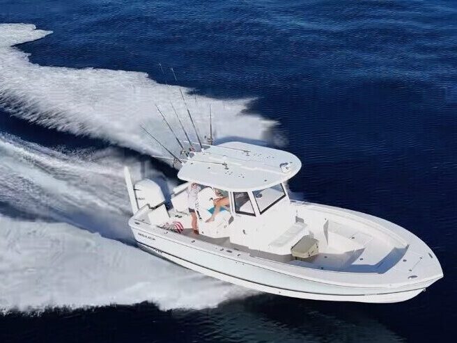 A fishing charter boat filled with happy customers cruising through the beautiful blue ocean toward the sandbar location in Key West.