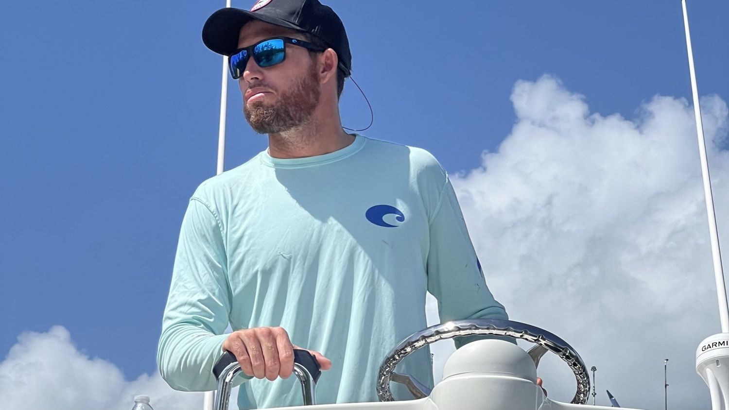 A charter captain driving boat during a fishing charter.