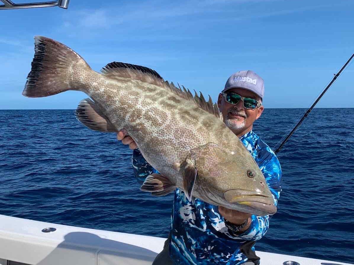 customer with large black grouper on private charter to the Dry Tortugas from key west