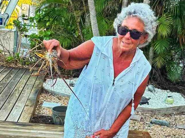 Woman holding a lobster during bully-netting trip in the Florida Keys.