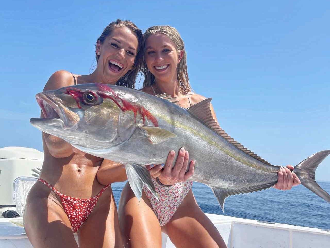 Amberjack Fish Pensacola Fishing Charter Reel Guides e1770210526102 Reel Guides Shauna Barton and Nicole Steffens posing with a large amberjack on a Pensacola fishing charter with Reel Guides