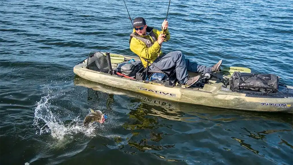 Best Fishing Kayaks fighting fish Reel Guides Angler fighting a fish from a fishing kayak on open water