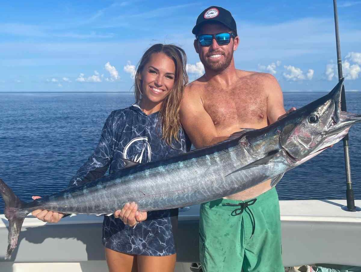 Wahoo Fish Pensacola Fishing Charter Reel Guides e1770210583373 Reel Guides Captain Kody Michael and Nicole Steffens holding a wahoo on a deep sea fishing trip in Pensacola with Reel Guides charter