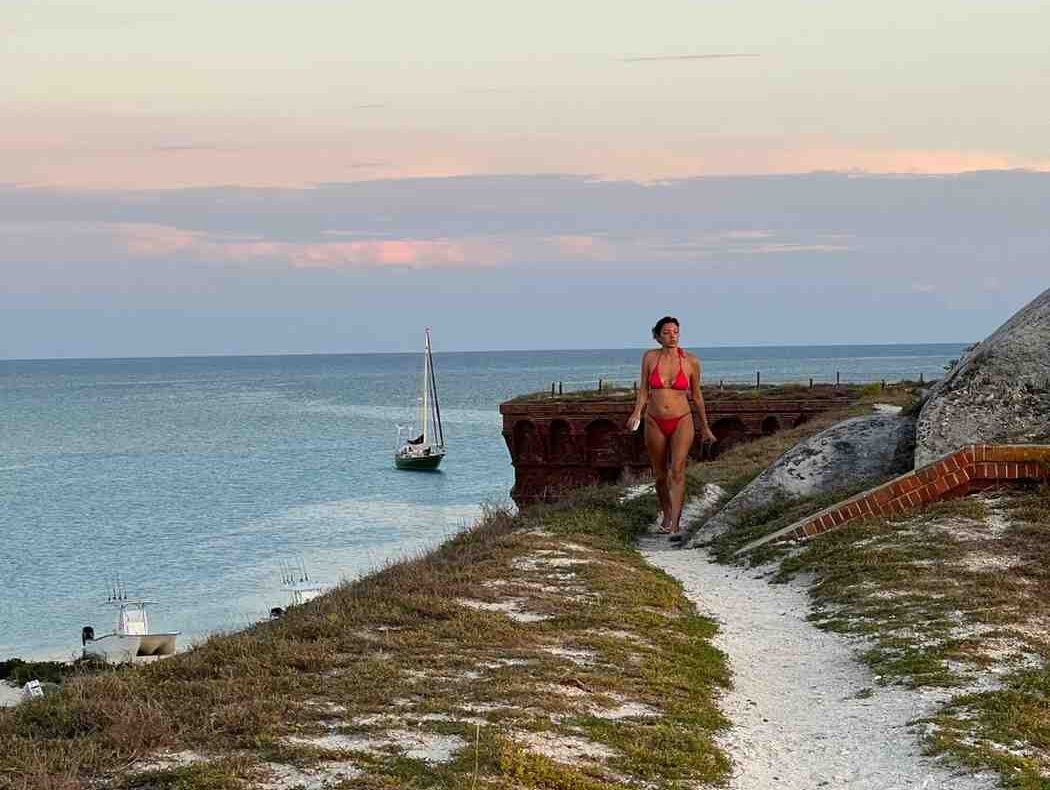 best charter to dry tortugas e1759427495945 Reel Guides Sunset over Fort Jefferson at Dry Tortugas National Park with vibrant sky and ocean views.