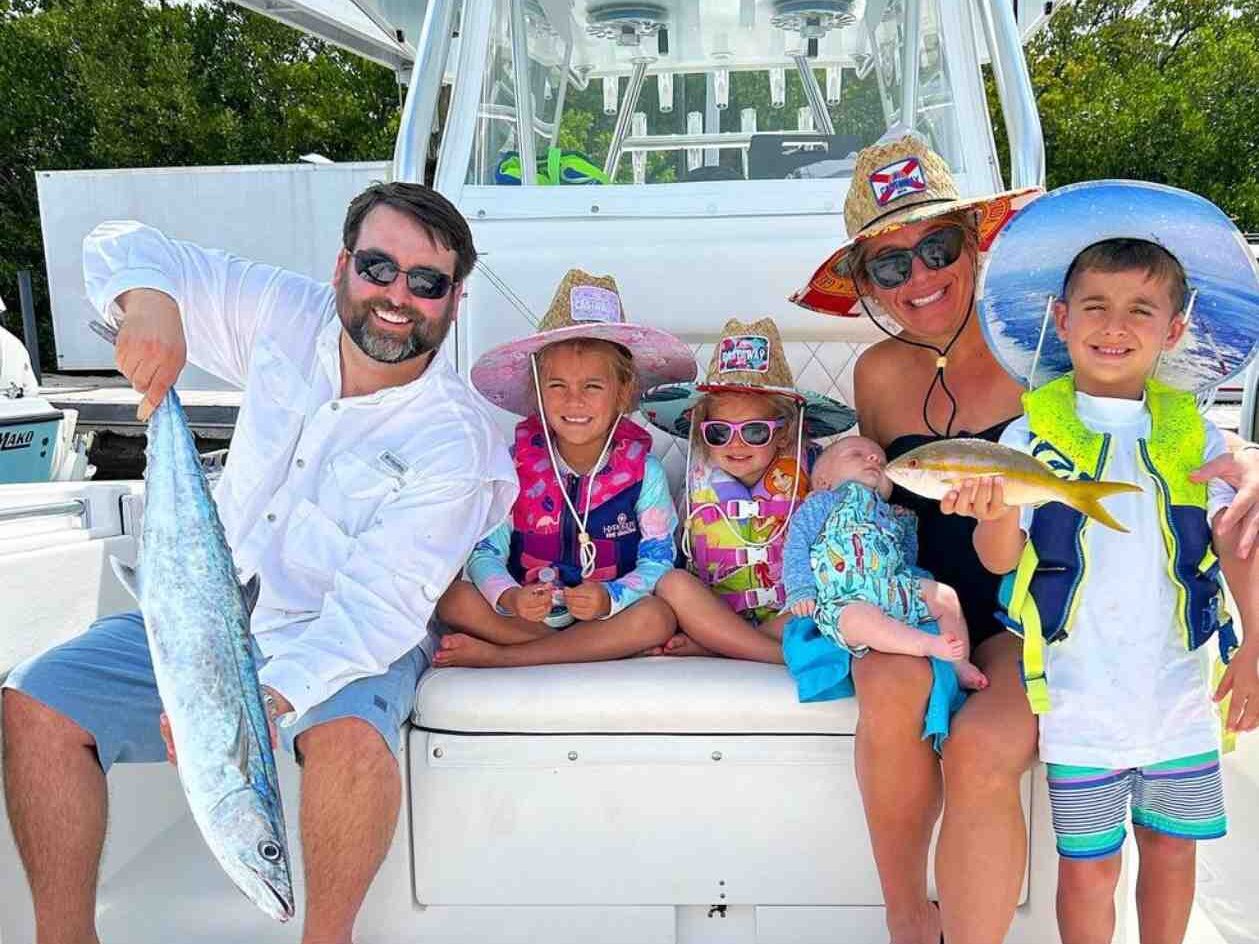 best kid friendly fishing charter key west e1759421828468 Reel Guides Family enjoying a fishing charter in Key West on a spacious boat, ideal for kids and adults.