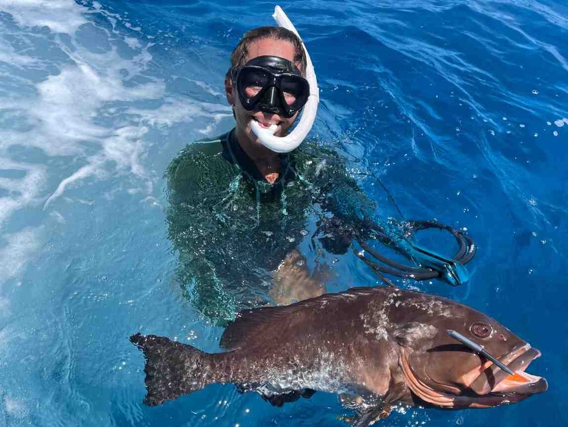 dry tortugas charter spearfishing e1759427517559 Reel Guides Spearfishing trip in the Dry Tortugas with diver in water with Red Grouper.