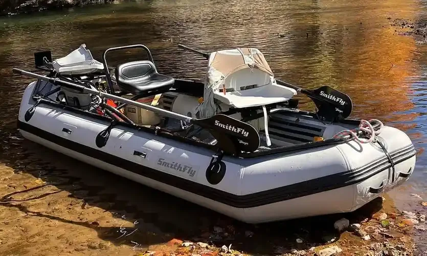 fishing in an inflatable boat e1775498299277 Reel Guides An inflatable boat on a lake