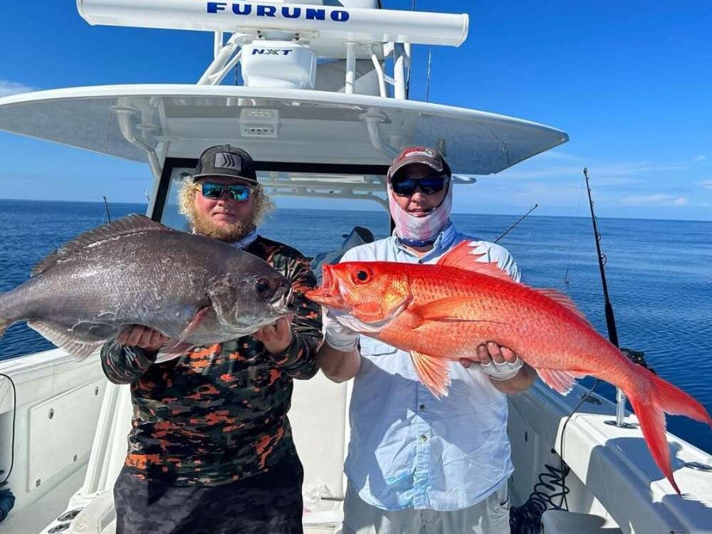 Two friends holding Barrel fish and Queen snapper while fishing Pulley Ridge. 