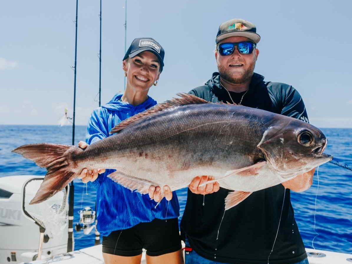 Two friends holding a barrel fish during pulley ridge fishing trip. 